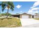 Charming home showcasing stone accents, mature landscaping and a spacious driveway at 11797 David Ct, Largo, FL 33778