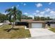 Charming single story home with a mature palm tree and a two car garage at 11797 David Ct, Largo, FL 33778
