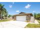 Spacious garage featuring stone accents and a large driveway at 11797 David Ct, Largo, FL 33778