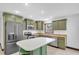 Kitchen featuring stainless steel appliances, green cabinets, granite countertops, and a breakfast bar at 11797 David Ct, Largo, FL 33778