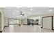 Open-concept layout with a kitchen featuring stainless steel appliances and tiled flooring at 11797 David Ct, Largo, FL 33778