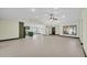 Open-concept living space with sleek tile flooring, offering flexibility and style at 11797 David Ct, Largo, FL 33778