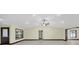 Open living room with tile flooring and access to the front door at 11797 David Ct, Largo, FL 33778