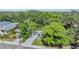 Aerial view of a charming home with mature trees, a well-manicured lawn, and a private driveway at 120 12Th N Ave, Safety Harbor, FL 34695