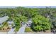 Aerial view of a cozy home with mature trees, a well-manicured lawn, and a private driveway at 120 12Th N Ave, Safety Harbor, FL 34695