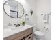 Modern bathroom with wooden vanity, decorative mirror, and minimalist decor at 120 12Th N Ave, Safety Harbor, FL 34695