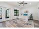 Bright bedroom with gray wood floors, flower art, area rug, and outdoor access at 120 12Th N Ave, Safety Harbor, FL 34695