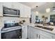 Bright kitchen with stainless steel microwave and oven, modern fixtures and hardware at 120 12Th N Ave, Safety Harbor, FL 34695