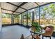 Relaxing screened patio with comfortable seating and a view of the fenced backyard at 120 12Th N Ave, Safety Harbor, FL 34695