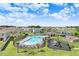 Aerial view of community pool and playground surrounded by homes and greenery at 12168 Lily Magnolia Ln, Riverview, FL 33569