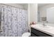 The bathroom features a floral shower curtain and a modern vanity at 12168 Lily Magnolia Ln, Riverview, FL 33569
