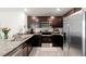 Modern kitchen featuring stainless steel appliances and granite countertops at 12168 Lily Magnolia Ln, Riverview, FL 33569