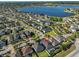 Aerial view of the home showcasing a lake view and the community with lush greenery at 12206 Blue Pacific Dr, Riverview, FL 33579