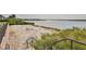 Tranquil beach area with comfortable lounge chairs and scenic lake views, perfect for relaxing by the water at 12206 Blue Pacific Dr, Riverview, FL 33579
