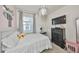Modern bedroom with white walls, carpeted floors, and a large window with blinds at 12206 Blue Pacific Dr, Riverview, FL 33579