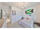 Bedroom featuring carpeted floors, a chandelier, and access to other rooms at 12206 Blue Pacific Dr, Riverview, FL 33579