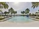 The community pool features sun loungers and lush tropical landscaping, creating a resort-like atmosphere at 12206 Blue Pacific Dr, Riverview, FL 33579