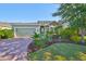 Charming single Gathering home with a beautifully landscaped front yard and brick paver driveway at 12206 Blue Pacific Dr, Riverview, FL 33579