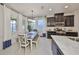 Eat-in kitchen with granite countertops, stainless appliances, and a bright dining area with natural light at 12206 Blue Pacific Dr, Riverview, FL 33579