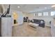 Upstairs bonus living room with cozy furniture, television, mini fridge, and workspace at 12206 Blue Pacific Dr, Riverview, FL 33579