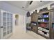 Bright home office with tile flooring, filled with storage, featuring double doors to other areas of the home at 12206 Blue Pacific Dr, Riverview, FL 33579