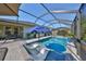 The sparkling blue pool has sun loungers and an umbrella, perfect for outdoor relaxation at 12206 Blue Pacific Dr, Riverview, FL 33579