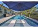 Enjoy outdoor living at its finest in this pool with built in loungers and shade umbrella at 12206 Blue Pacific Dr, Riverview, FL 33579