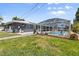 Backyard with pool, screened enclosure, and grassy lawn at 170 Argus Rd, Venice, FL 34293