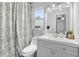Bathroom featuring a modern vanity, patterned shower curtain, and natural light from the window at 170 Argus Rd, Venice, FL 34293