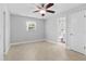 A well-lit and spacious bedroom features wood-style flooring and a neutral color palette at 170 Argus Rd, Venice, FL 34293