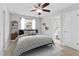 Cozy bedroom with a wooden frame bed, complemented by a window view and simple decor at 170 Argus Rd, Venice, FL 34293