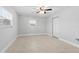 Neutral bedroom with light wood floors, a ceiling fan, a window, and a closet at 170 Argus Rd, Venice, FL 34293
