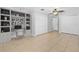 Staged bedroom with built-in desk and shelving, hardwood floors, and closet space at 170 Argus Rd, Venice, FL 34293