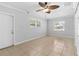 Open bedroom with tile flooring, neutral walls, ceiling fan, and plenty of natural light at 170 Argus Rd, Venice, FL 34293