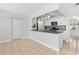 Modern kitchen bar with granite countertops, white cabinets, and pendant lighting at 170 Argus Rd, Venice, FL 34293