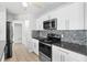 Well-equipped kitchen with stainless steel appliances, granite countertops, and ample storage at 170 Argus Rd, Venice, FL 34293