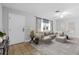 Bright living room with neutral colors, tile flooring, and a large sectional sofa for comfortable living at 170 Argus Rd, Venice, FL 34293
