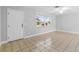 The living room is bathed in natural light from a large window, highlighting the neutral walls and tile floor at 170 Argus Rd, Venice, FL 34293