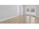 Bright room featuring neutral paint, tile flooring, and French doors to the pool area at 170 Argus Rd, Venice, FL 34293