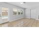 Bright living room featuring tile floors, large windows, and a door leading to the pool area at 170 Argus Rd, Venice, FL 34293