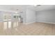 Open-concept living room with tile flooring, adjacent to kitchen and overlooking the pool area at 170 Argus Rd, Venice, FL 34293