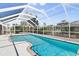 A refreshing screened-in pool with clear blue water and a serene backyard setting for relaxation and enjoyment at 170 Argus Rd, Venice, FL 34293
