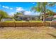 A spacious backyard featuring a screened-in pool area, a fire pit, and manicured landscaping at 18836 Green Park Rd, Hudson, FL 34667