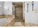 Bathroom featuring a glass shower, granite topped tub, and decorative accents at 18836 Green Park Rd, Hudson, FL 34667