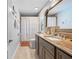 Bathroom with gray cabinets, granite countertops, and a shower with a curtain at 18836 Green Park Rd, Hudson, FL 34667