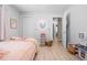 Bedroom with light wood flooring, a cozy bed, and stylish decor at 18836 Green Park Rd, Hudson, FL 34667