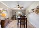 Charming dining area featuring a stylish ceiling fan and a large, picturesque window at 18836 Green Park Rd, Hudson, FL 34667