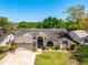 Charming single-story home with tile roof, well-manicured lawn, and inviting curb appeal in a tranquil neighborhood at 18836 Green Park Rd, Hudson, FL 34667