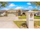 Charming home with a well-manicured lawn, an attached two-car garage and elegant front doorway at 18836 Green Park Rd, Hudson, FL 34667