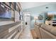 Hallway with coastal decor and a glimpse into a laundry room with white appliances and storage at 18836 Green Park Rd, Hudson, FL 34667
